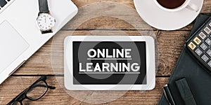 Text online learning on screen of table computer at office desk